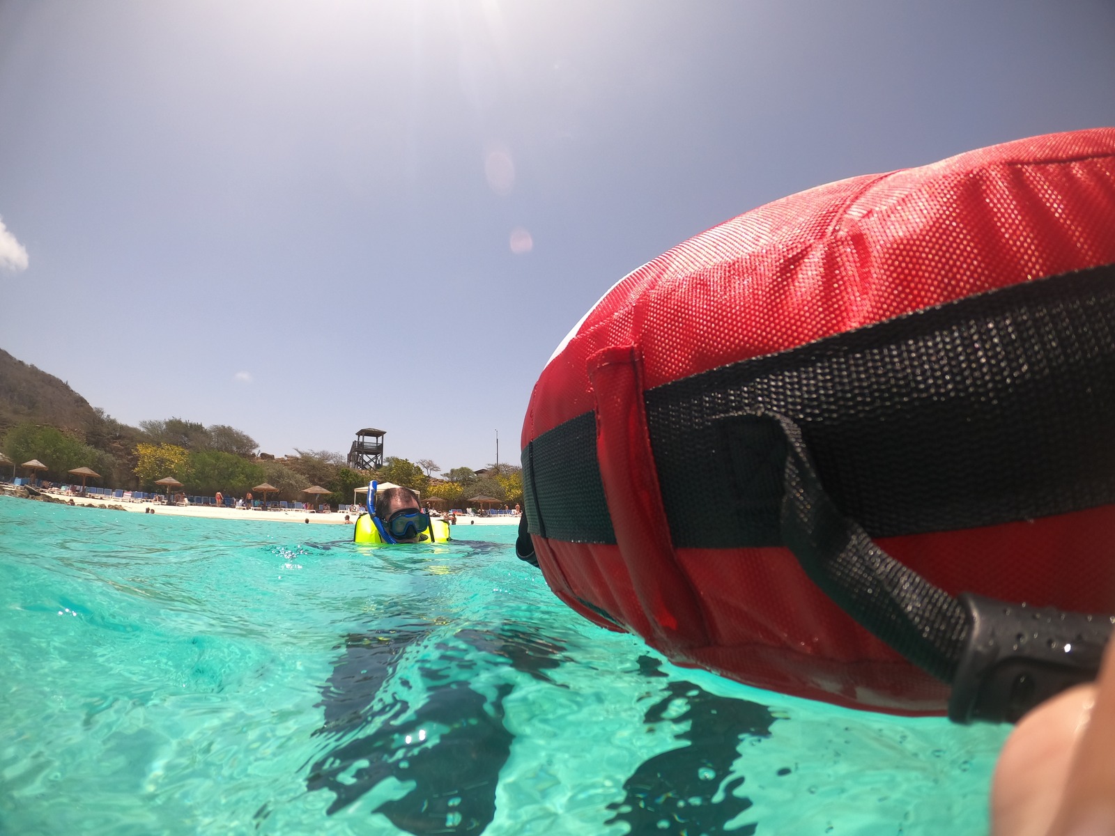 Bouée de sécurité rouge et nageurs en surface près de la plage, sortie snorkeling à Curaçao.
